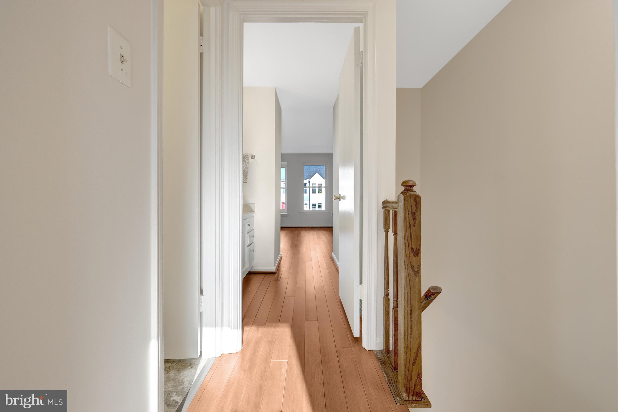 11200 Silentwood Lane Reston, VA 20191 - Photo 25 of 46 a view of a hallway with wooden floor and stairs