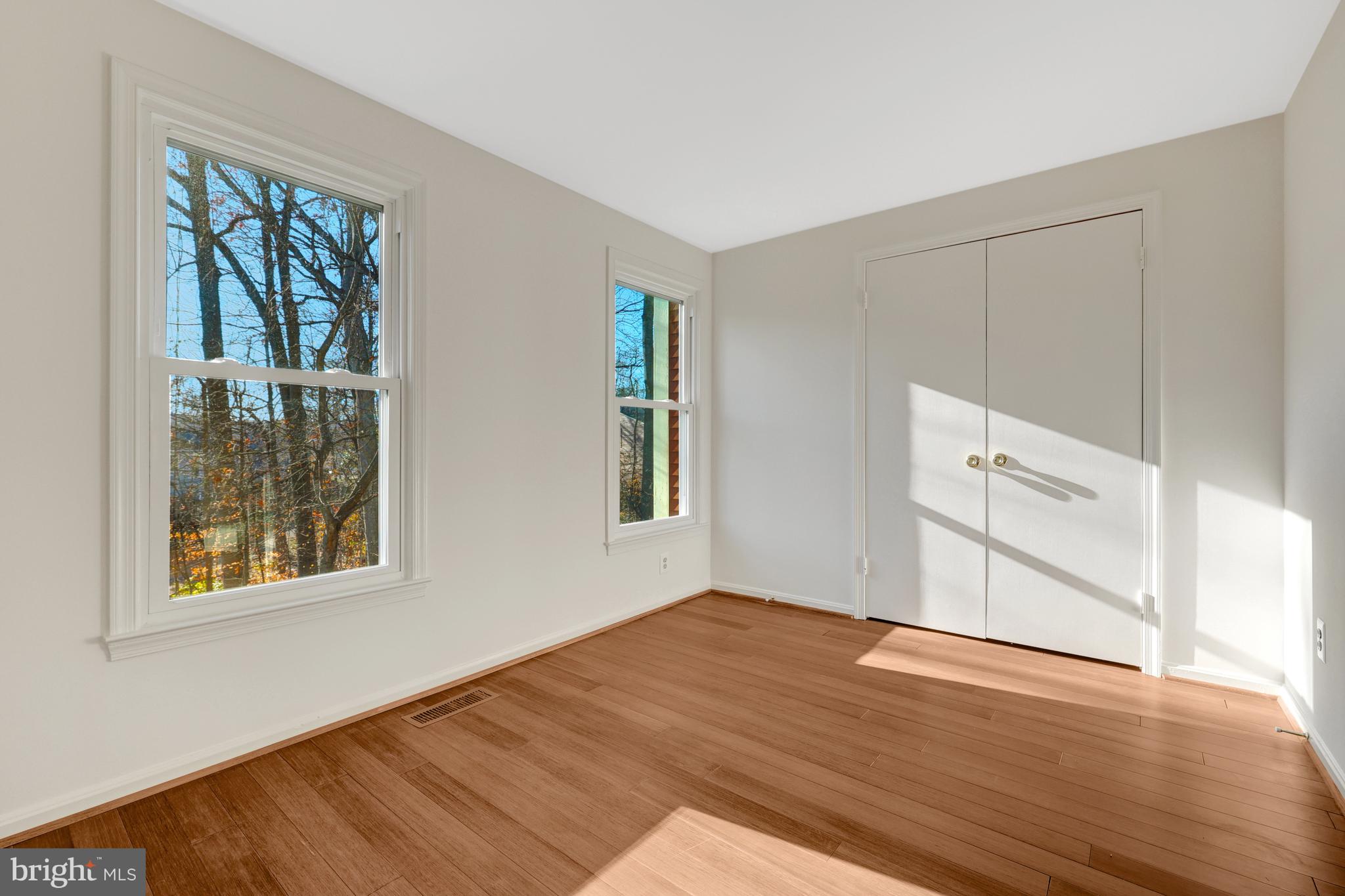 11200 Silentwood Lane Reston, VA 20191 - Photo 31 of 46 a view of an empty room with wooden floor and a window