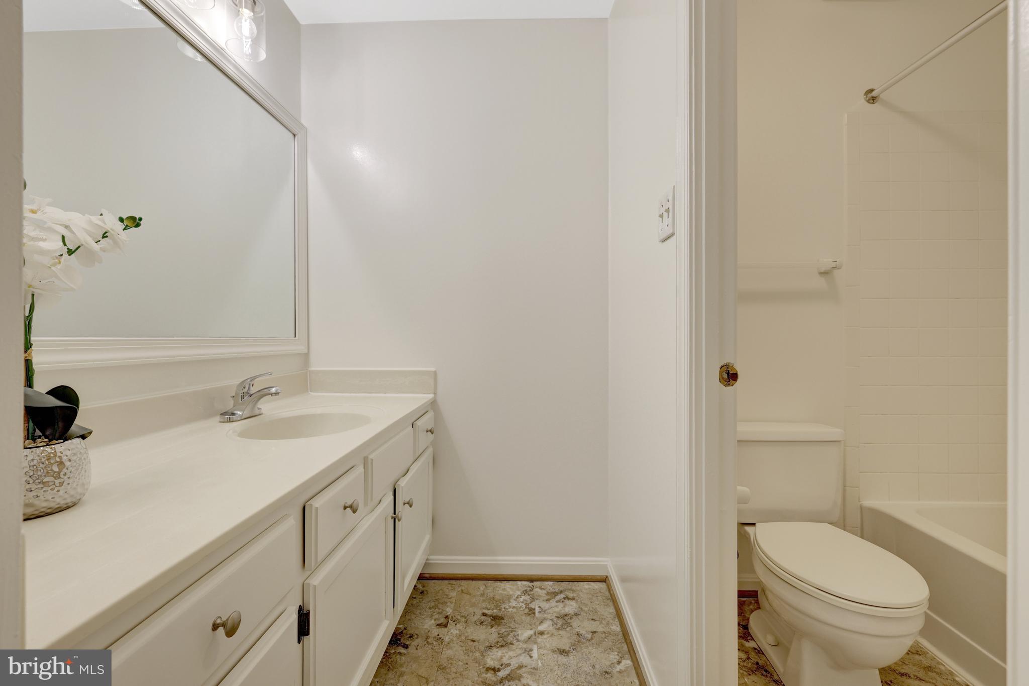 11200 Silentwood Lane Reston, VA 20191 - Photo 34 of 46 a bathroom with a granite countertop sink toilet and shower
