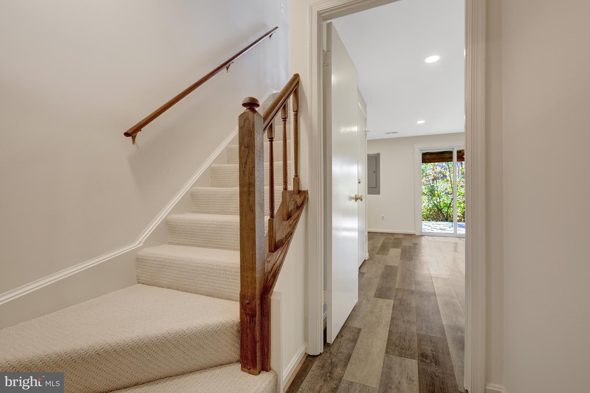 11200 Silentwood Lane Reston, VA 20191 - Photo 35 of 46 a view of a hallway with wooden floor and staircase
