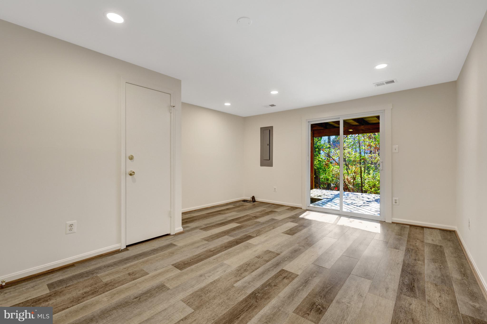 11200 Silentwood Lane Reston, VA 20191 - Photo 36 of 46 a view of an empty room with wooden floor and a window