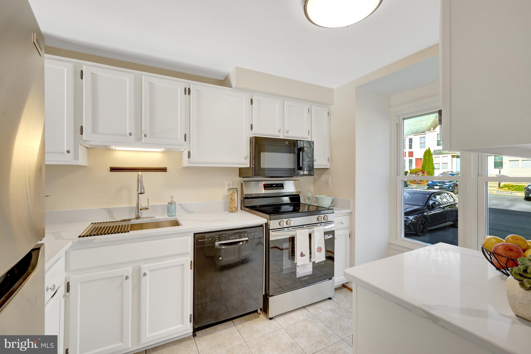 11200 Silentwood Lane Reston, VA 20191 - Photo 8 of 46 a kitchen with a sink stove and white cabinets