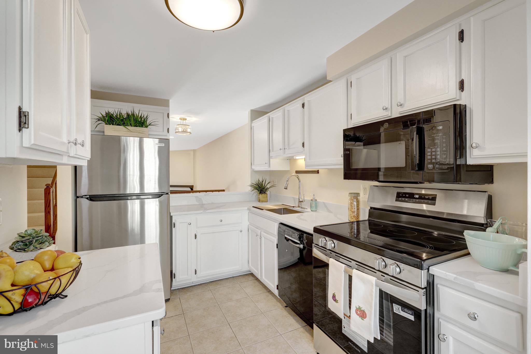 11200 Silentwood Lane Reston, VA 20191 - Photo 9 of 46 a kitchen with a sink appliances and cabinets