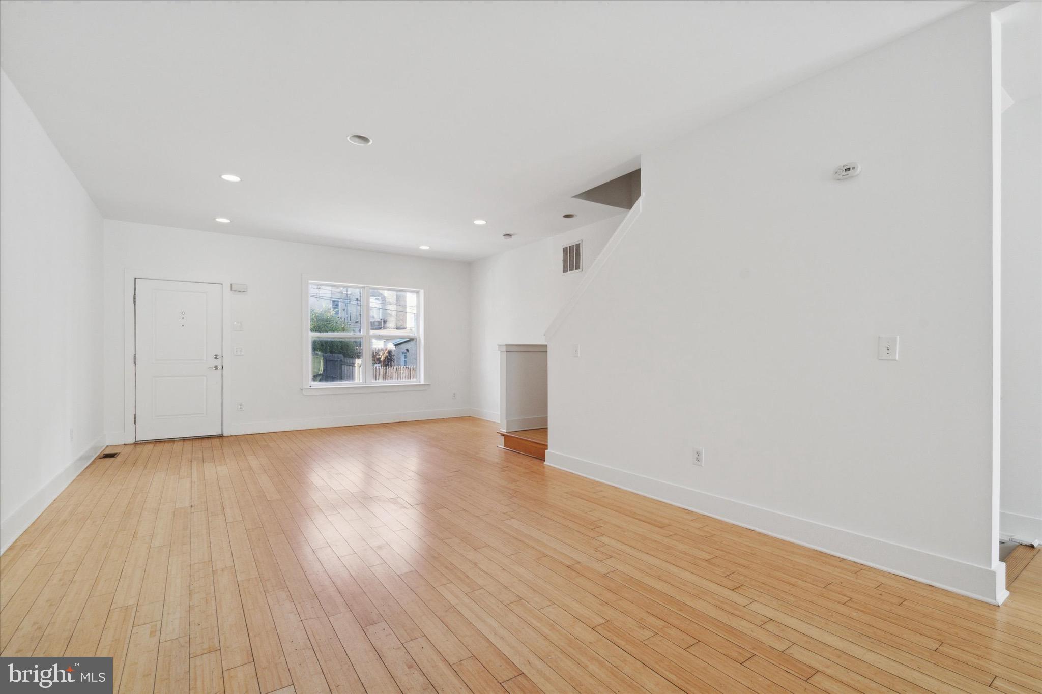 1345 Palethorp Street Philadelphia, PA 19122 - Photo 3 of 15 a view of an empty room with wooden floor and a window