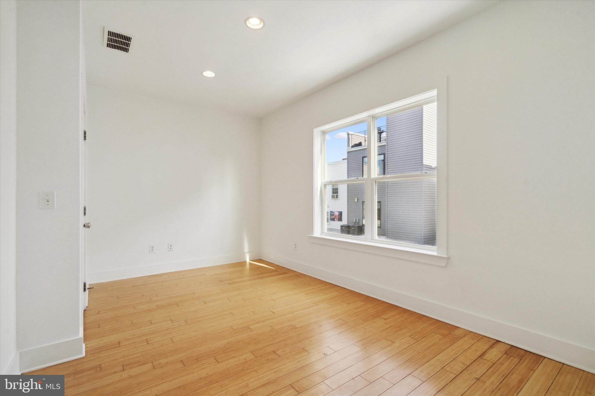 1345 Palethorp Street Philadelphia, PA 19122 - Photo 8 of 15 a view of an empty room with wooden floor and a window