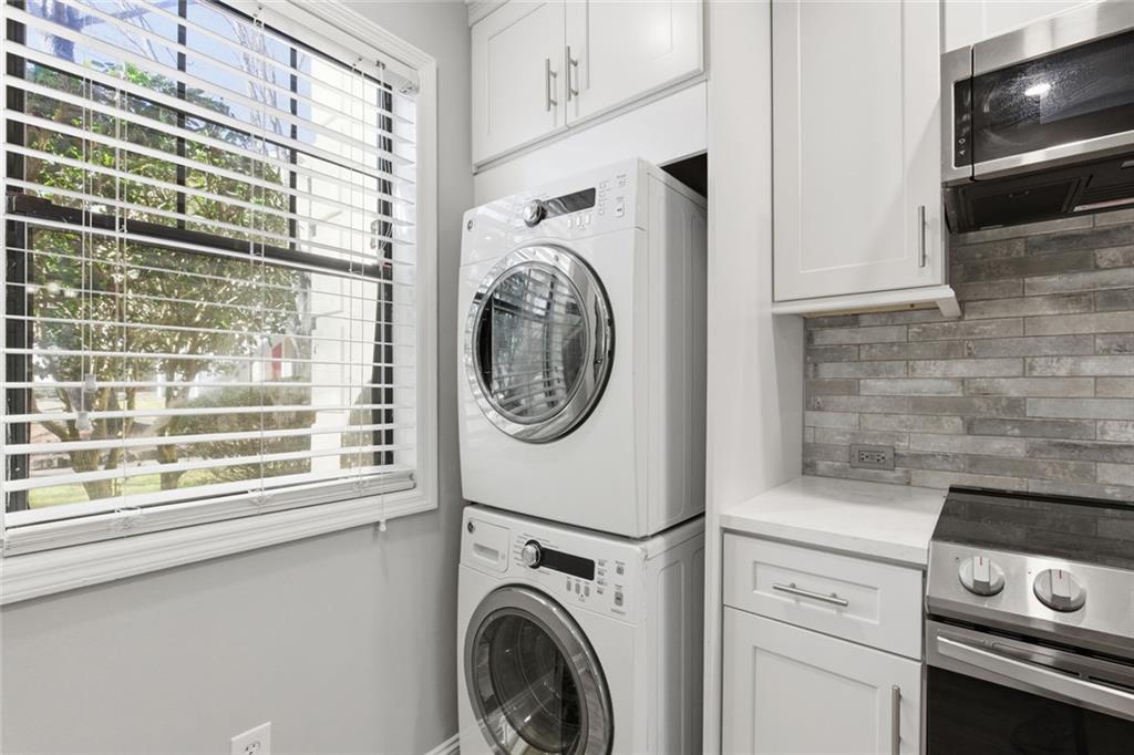 210 Appleby Drive, Unit 119 Athens, GA 30605 - Photo 14 of 35 a view of washer and dryer with kitchen in the background