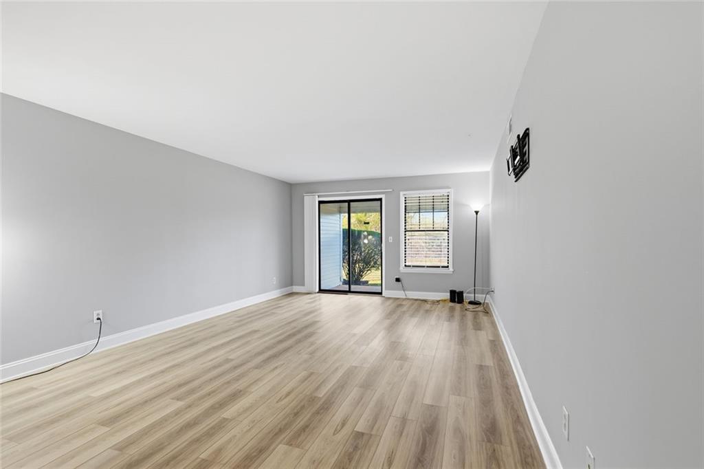210 Appleby Drive, Unit 119 Athens, GA 30605 - Photo 16 of 35 a view of an empty room with wooden floor and a window