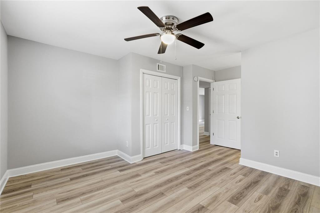 210 Appleby Drive, Unit 119 Athens, GA 30605 - Photo 20 of 35 an empty room with wooden floor and ceiling fan