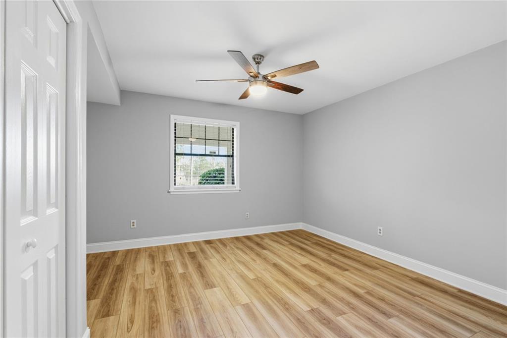 210 Appleby Drive, Unit 119 Athens, GA 30605 - Photo 25 of 35 an empty room with a window and ceiling fan