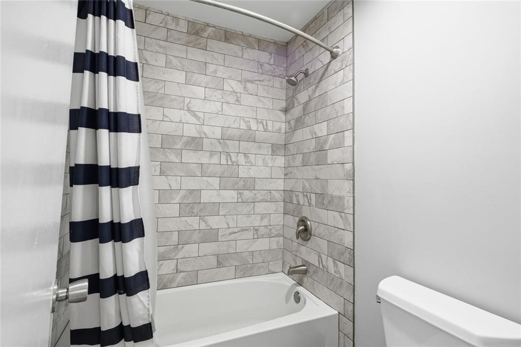 210 Appleby Drive, Unit 119 Athens, GA 30605 - Photo 28 of 35 a bathroom with a shower curtain and a sink
