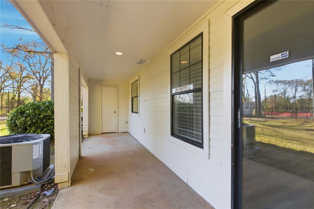 210 Appleby Drive, Unit 119 Athens, GA 30605 - Photo 29 of 35 a view of a hallway with wooden floor and a fireplace