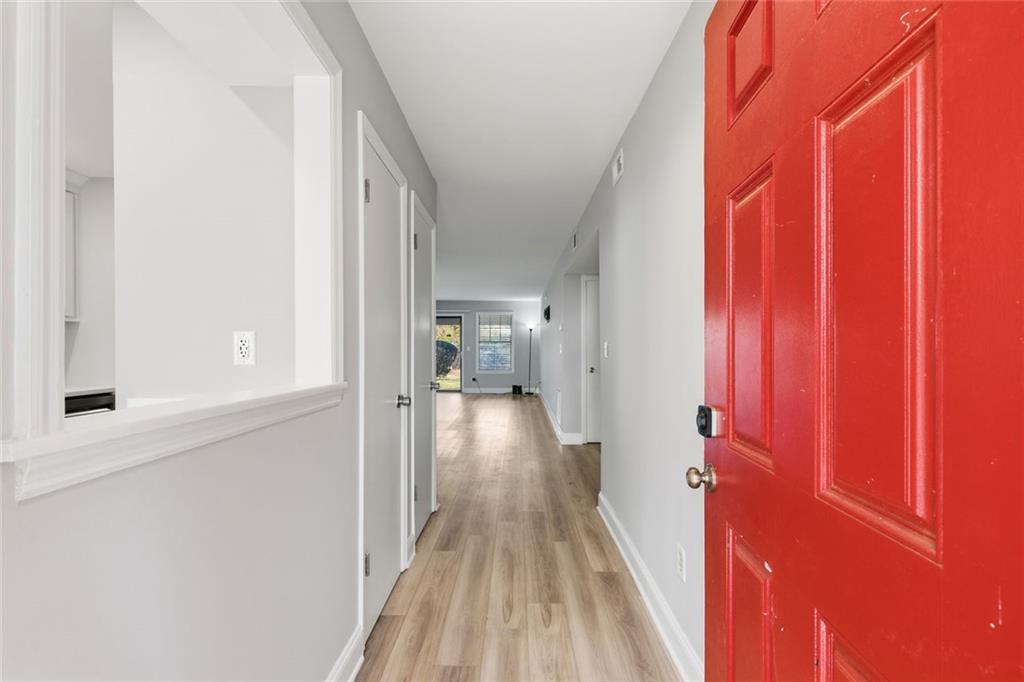 210 Appleby Drive, Unit 119 Athens, GA 30605 - Photo 7 of 35 a view of a hallway with wooden floor and a bathroom
