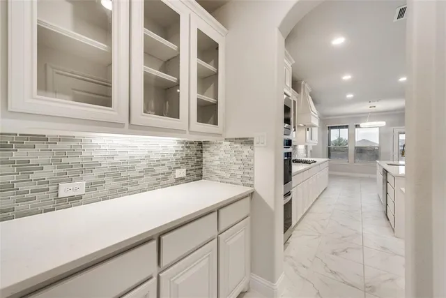 a view of a kitchen with a sink and cabinets