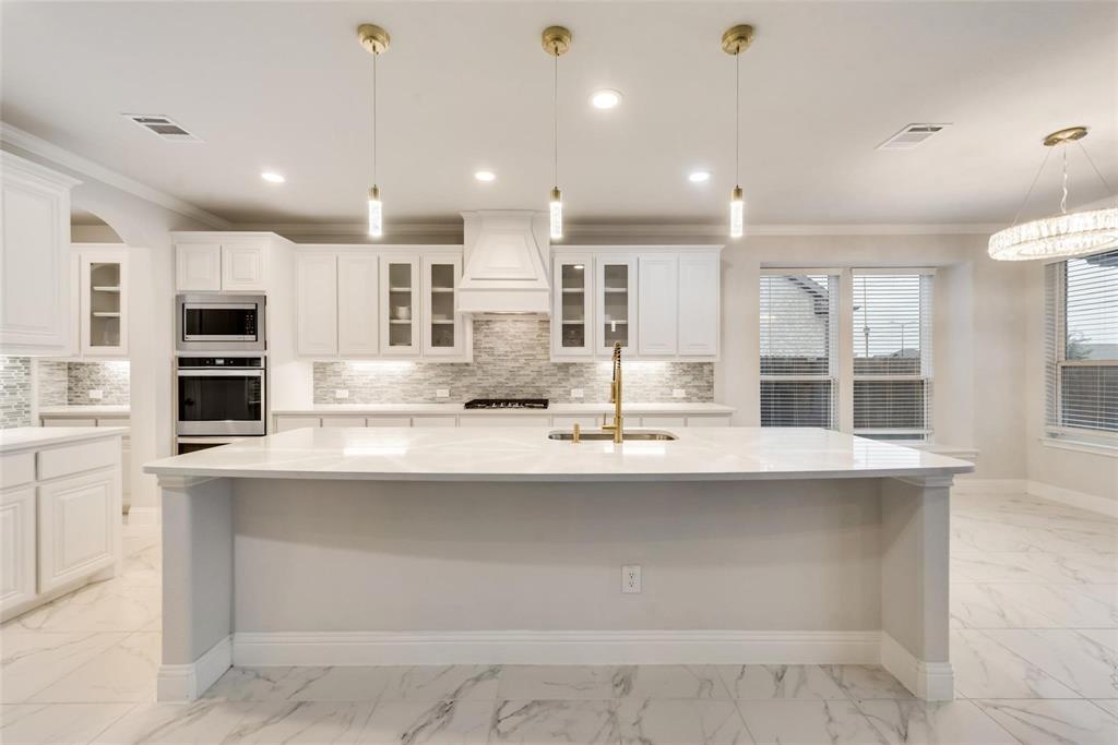 14623 Prairie Fire Drive Frisco, TX 75033 - Photo 13 of 36 a kitchen with kitchen island cabinets and appliances