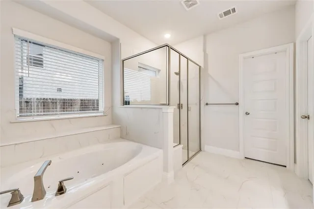 a bathroom with a bathtub and a shower