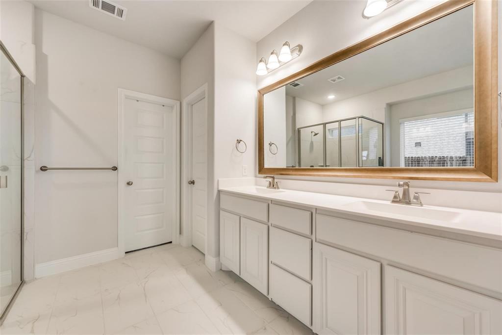 14623 Prairie Fire Drive Frisco, TX 75033 - Photo 17 of 36 a spacious bathroom with a double vanity sink and mirror