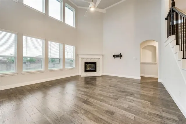 a view of empty room with wooden floor and fireplace