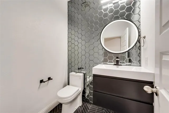 a bathroom with a toilet sink and mirror