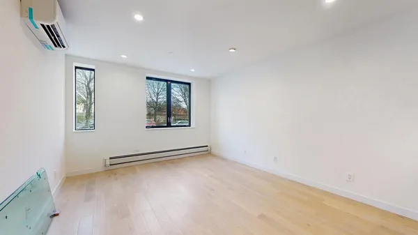 a large white kitchen with kitchen island a sink stainless steel appliances and cabinets
