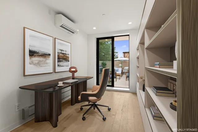 a view of a hallway with wooden floor and stairs