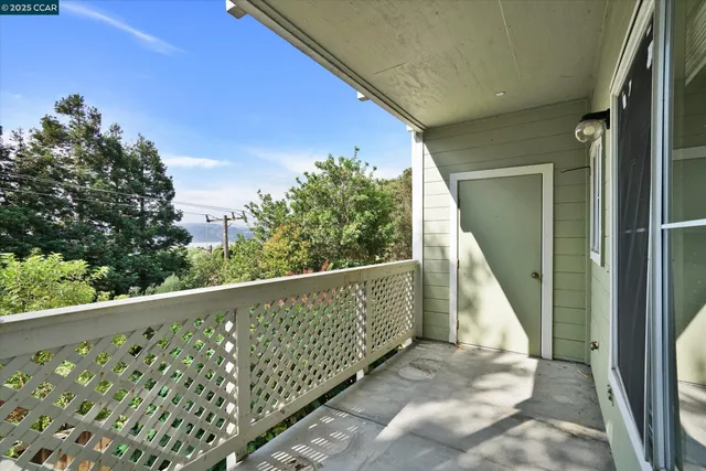 a view of balcony with wooden floor and fence