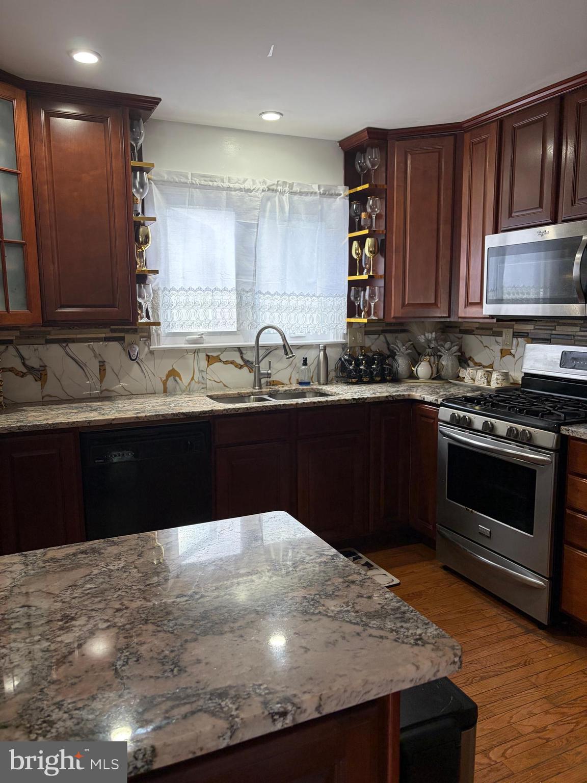7404 Wyndam Road Pennsauken, NJ 08110 - Photo 13 of 50 a kitchen with a sink and a stove