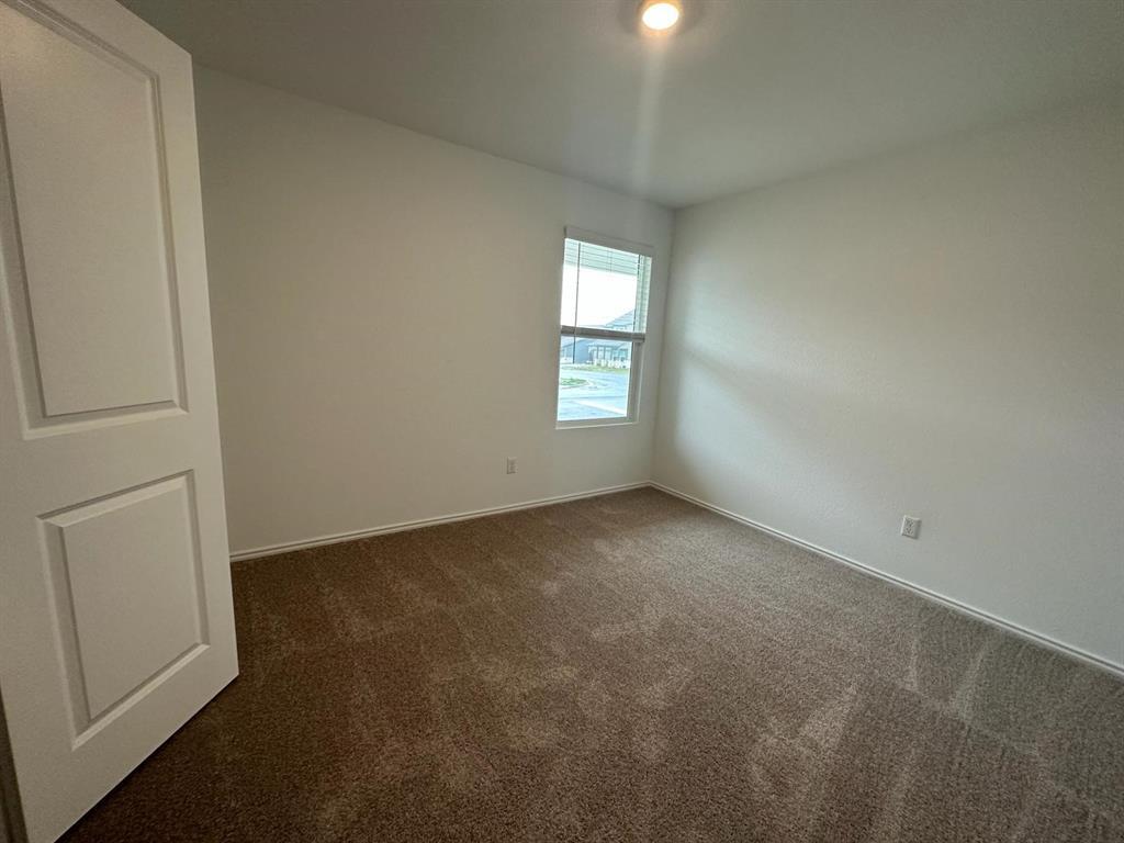 346 Carmello Kyle, TX 78640 - Photo 13 of 39 Empty room featuring dark colored carpet and baseboards
