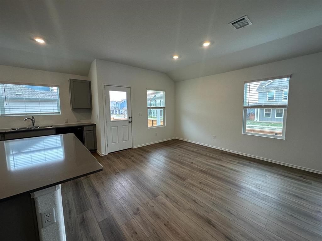 346 Carmello Kyle, TX 78640 - Photo 16 of 39 Kitchen featuring dark wood-type flooring, recessed lighting, vaulted ceiling, and gray cabinets