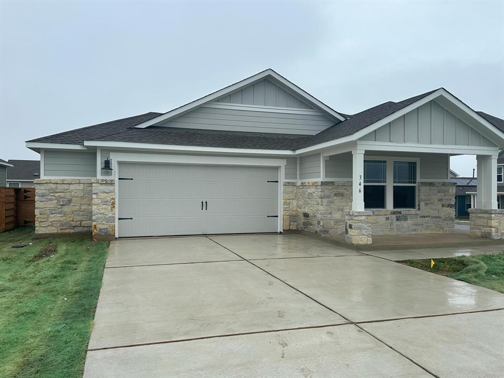 346 Carmello Kyle, TX 78640 - Photo 2 of 39 Craftsman-style house with board and batten siding, roof with shingles, stone siding, an attached garage, and concrete driveway