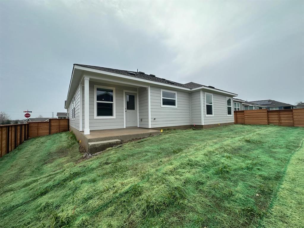 346 Carmello Kyle, TX 78640 - Photo 37 of 39 Back of property with a fenced backyard, a patio, and roof with shingles