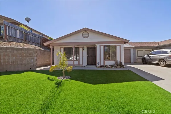 a view of a house with a yard porch and sitting area