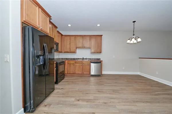 a kitchen with a refrigerator sink and cabinets