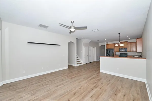 a view of a kitchen with a sink and a refrigerator