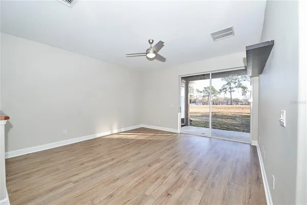 a view of a room with wooden floor staircase and a kitchen