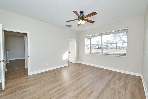 a spacious bathroom with a tub sink and mirror