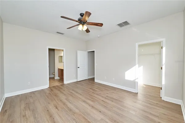 a bathroom with a granite countertop toilet a sink and a mirror