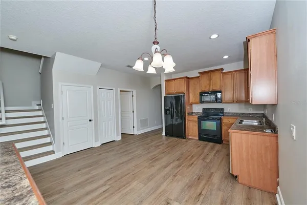 a view of a room with wooden floor and ceiling fan