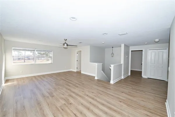 a view of a room with wooden floor and white walls