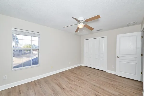 an aerial view of a house with a yard and lake view