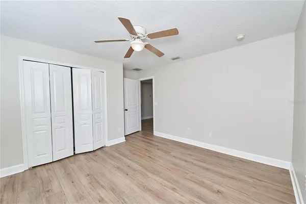an aerial view of a swimming pool with outdoor seating and yard