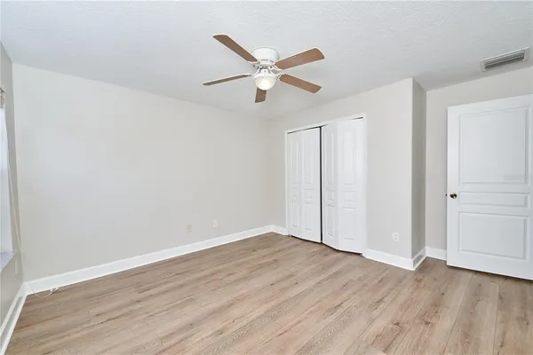 an aerial view of a house with outdoor space and tennis court