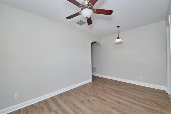 a view of an empty room with a ceiling fan
