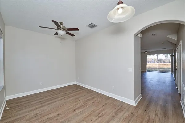 a view of a room with wooden floor and fan
