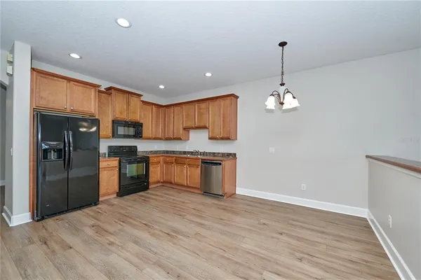 a kitchen with granite countertop stainless steel appliances and refrigerator