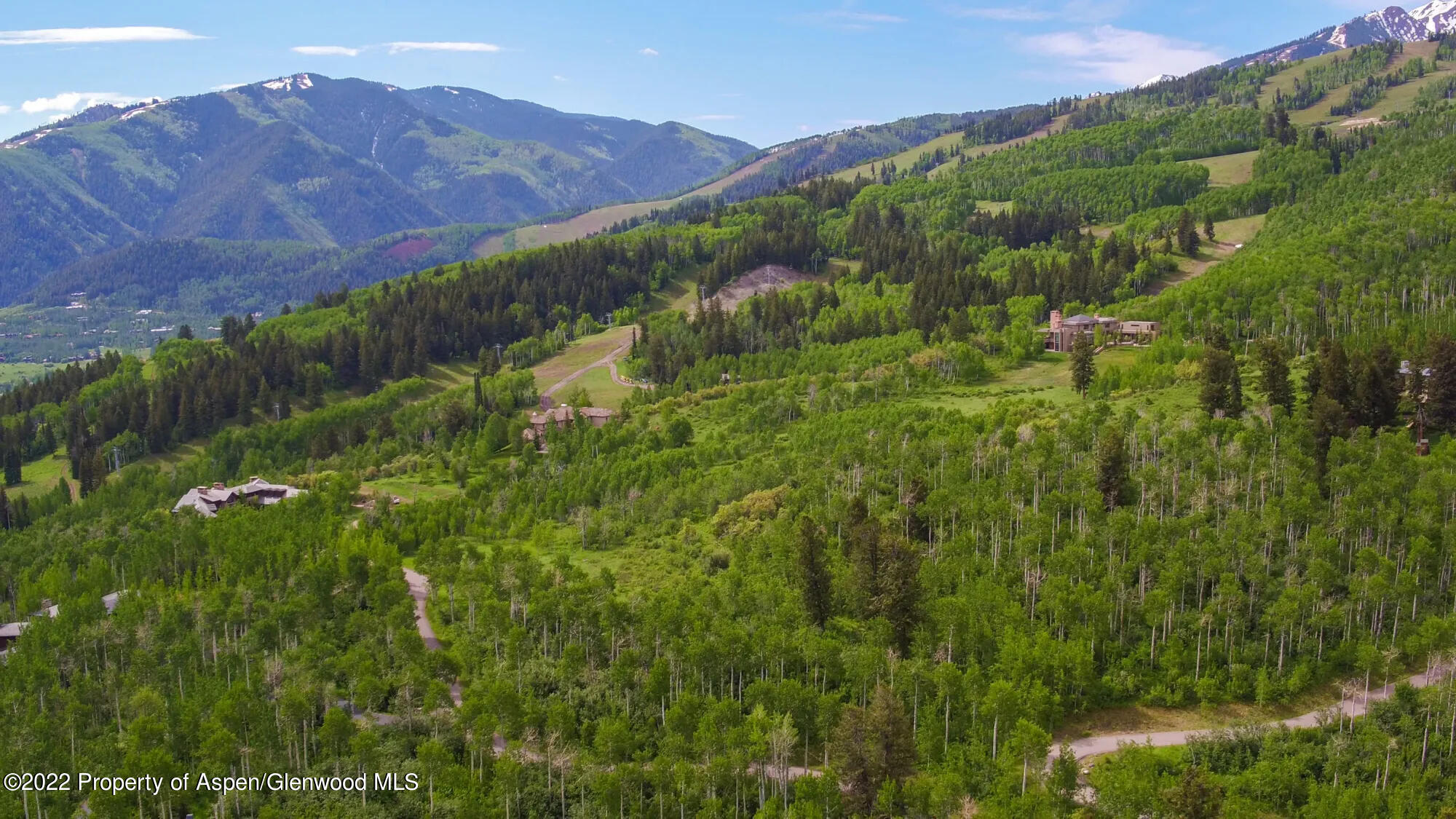 a view of a lush green hillside and a building