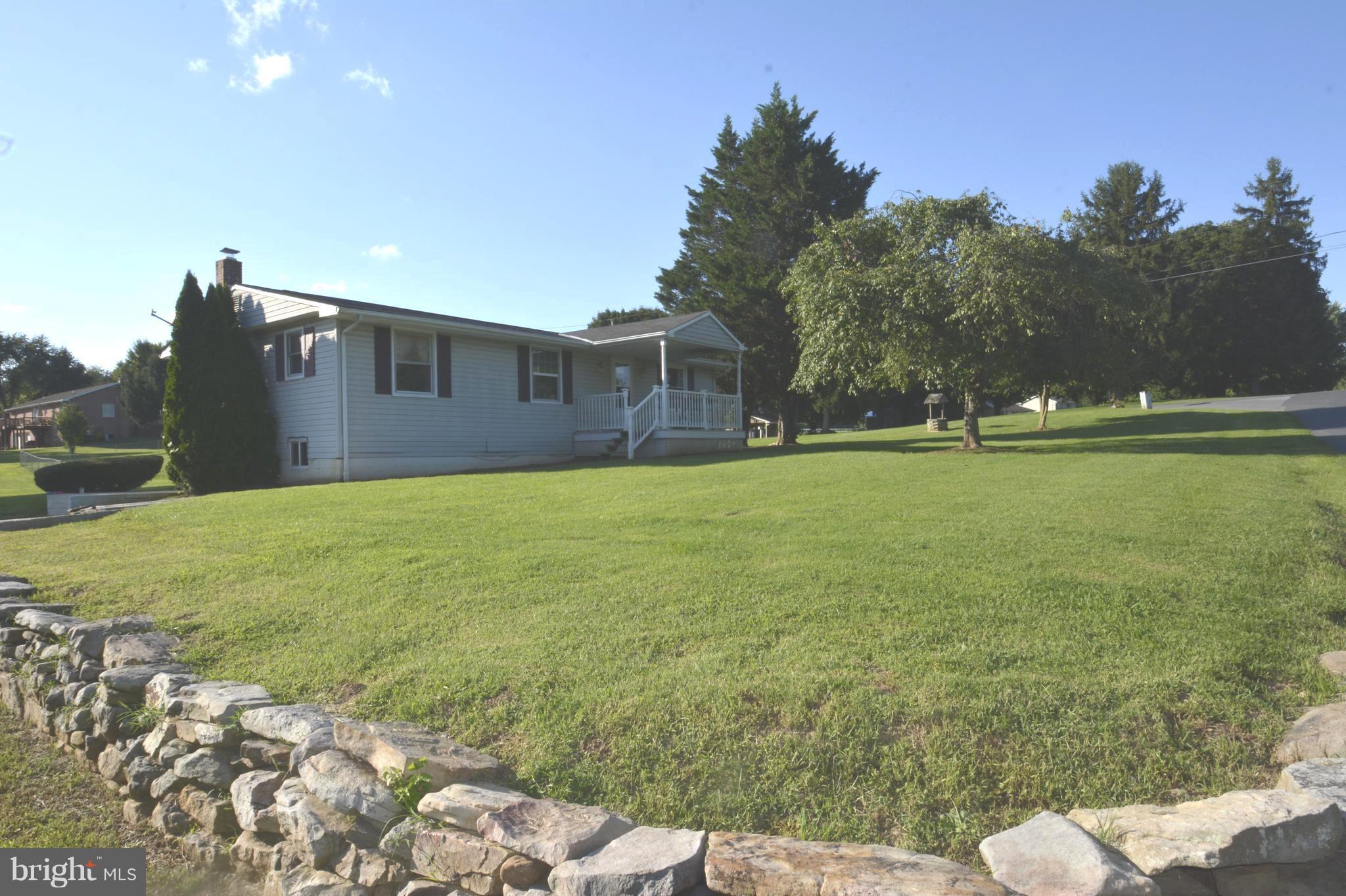 165 Lockhouse Road Falling Waters, WV 25419 - Photo 1 of 18 a house with a garden in front of it