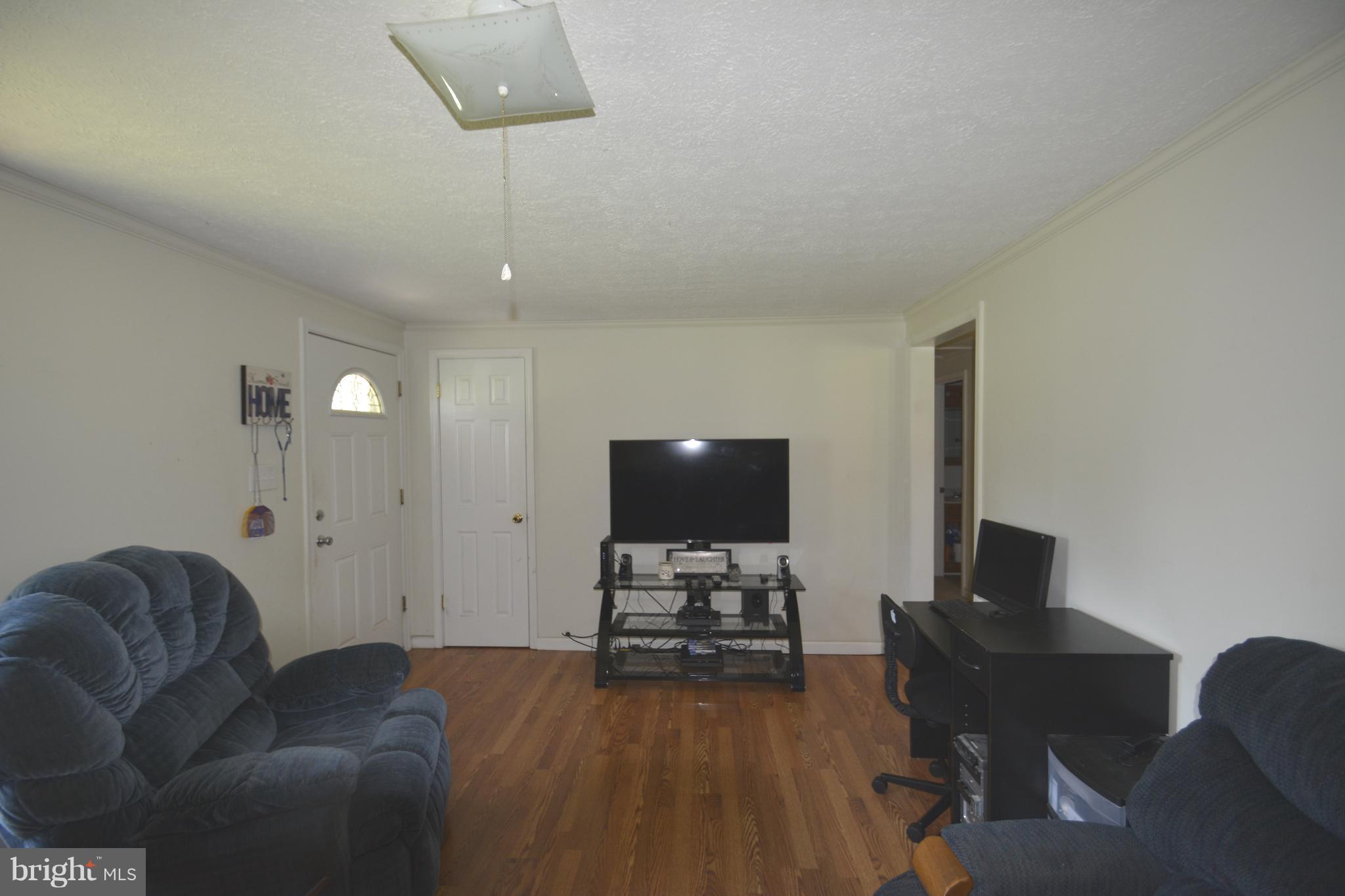 165 Lockhouse Road Falling Waters, WV 25419 - Photo 3 of 18 a living room with furniture and a flat screen tv