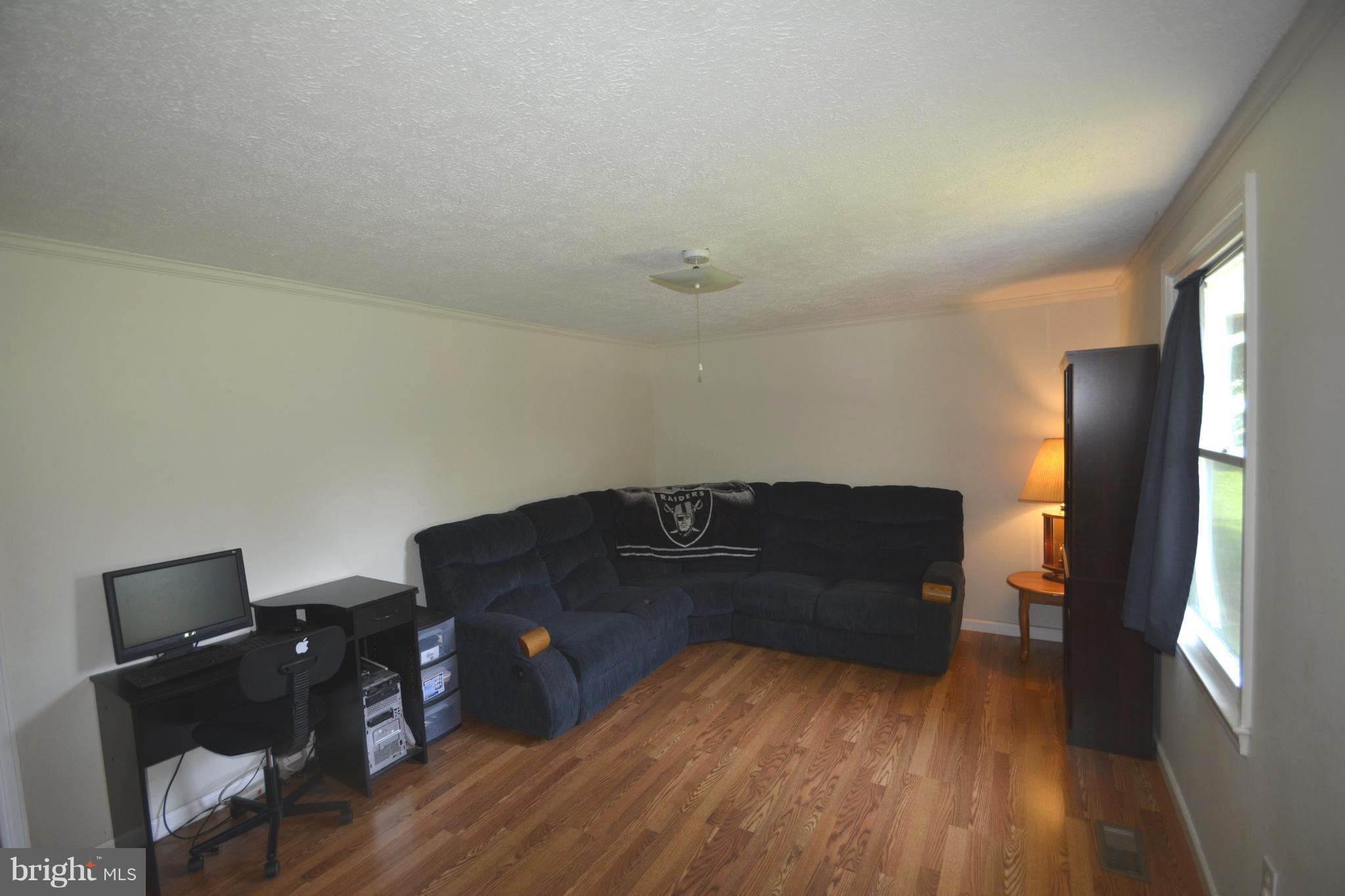 165 Lockhouse Road Falling Waters, WV 25419 - Photo 4 of 18 a living room with furniture and a wooden floor