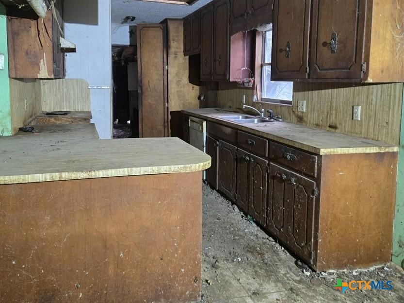 1807 North Wheeler Street Victoria, TX 77901 - Photo 4 of 4 a kitchen with stainless steel appliances granite countertop a sink stove and refrigerator
