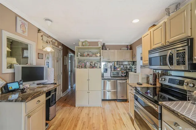 a kitchen with a sink appliances and cabinets